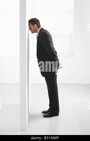 Businessman Leaning on Wall