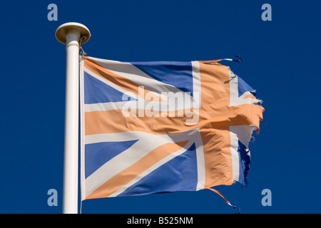 A tattered British flag waves in the wind Stock Photo