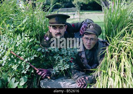 Cast of Blackadder Goes Forth in costume for photocall Black Adder Rowan Atkinson Baldrick Tony Robinson Holding batton stick Wartime Cunning Plan Crawling through undergrowth September 1989 1980s First World War WW1 Great War Stock Photo