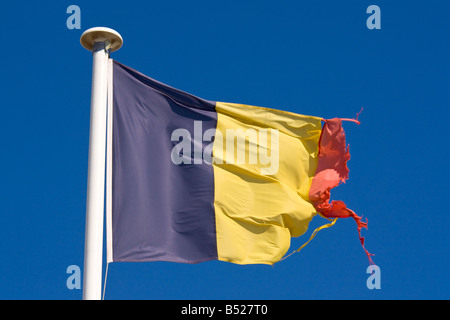 A tattered Belgian flag waves in the wind Stock Photo