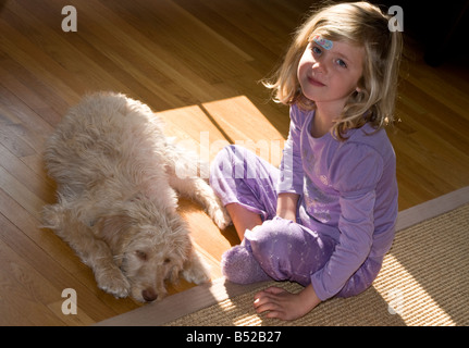 Young girl pet dog Labadoodle Stock Photo