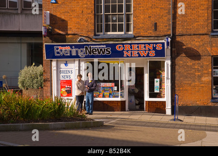 Green's News the newsagent in Norwich,Norfolk,Uk with customers standing outside Stock Photo