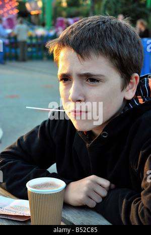 Boy drinking hot chocolate at sunset Stock Photo