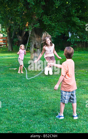 young girls jumping rope at family summer picnic outing Stock Photo