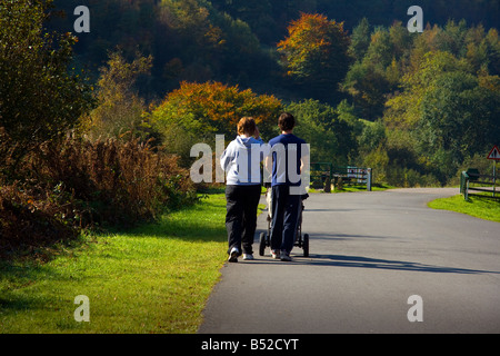 Couple with pushchair Forest Drive Cwmcarn Gwent South Wales Stock Photo