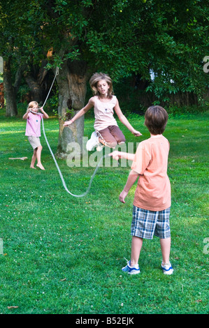 young girls jumping rope at family summer picnic outing Stock Photo