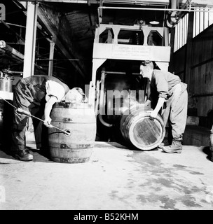 A barrel inspector at work at Hancock's Brewery in Cardiff. July 1952 C3603-003 Stock Photo