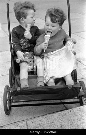 Holiday scenes. in and around Hastings. Two young boys in their pram enjoy a holiday ice cream  June 1952 C2779-003 Stock Photo