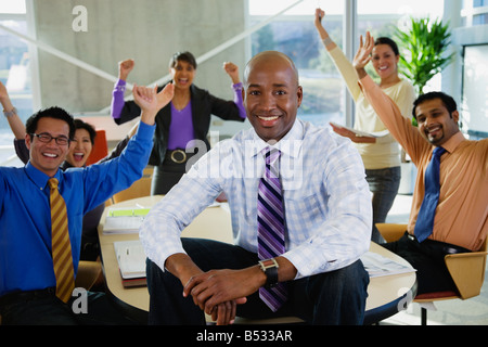 Multi-ethnic business people celebrating in meeting Stock Photo