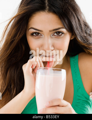 Middle Eastern woman drinking smoothie Stock Photo