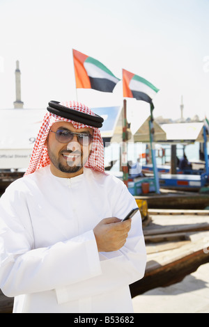 Arab man holding cell phone Stock Photo