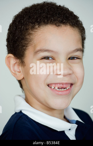 Mixed race boy smiling with missing teeth Stock Photo