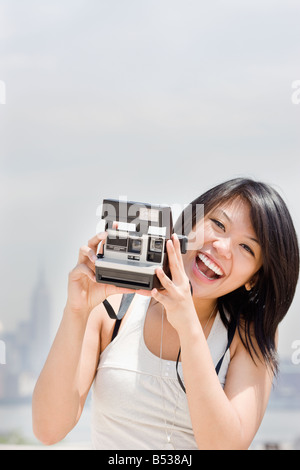 Asian woman with instant camera Stock Photo