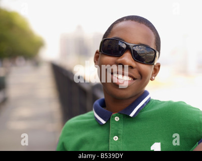 Smiling Teenage Boy Sunglasses Taking Notes Looking Away While