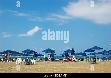 Sun beds and shade umbrellas on Rethymno beach Crete Greece September 2008 Stock Photo