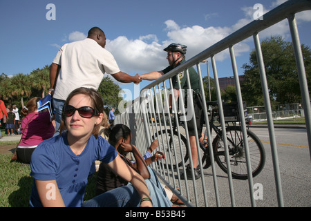 Man shakes hands with a man in the Orlando Police Department Bike Unit, Amway Arena before the Obama Early Vote for Change Rally Stock Photo