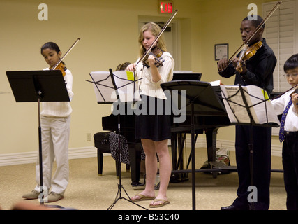 Four Young Violin Students Stock Photo