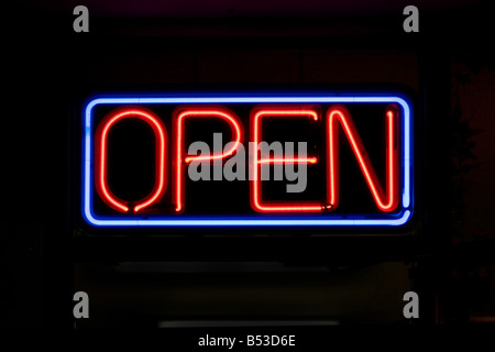 A neon OPEN sign commonly seen in businesses Stock Photo