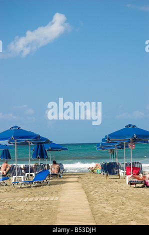 Sun beds and shade umbrellas on Rethymno beach Crete Greece September 2008 Stock Photo