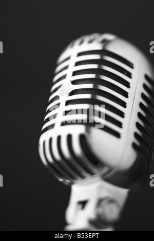 Classic retro microphone on black background selective focus Stock Photo