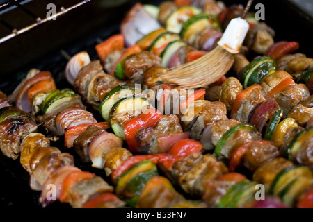 Beef shish kebabs on skewers cooking on the grill Stock Photo