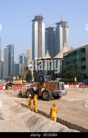 Labourers work on the road reconstruction outside the City Centre shopping mall right in Doha Qatar Stock Photo