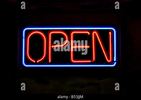 A neon OPEN sign glowing red in the window of a restaurant Stock Photo