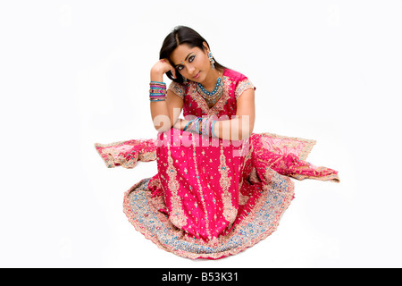 Beautiful Bengali bride in colorful dress day dreaming isolated Stock Photo