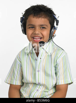 asian boy enjoying music with headphones Stock Photo