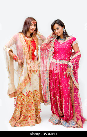 Two beautiful Bangali brides in colorful dresses isolated Stock Photo