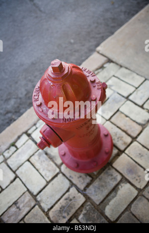 Red fire hydrant on rural road in Comfort, TX Stock Photo