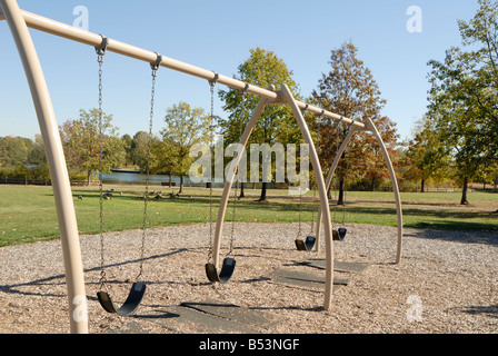 empty swing set on playground in fall Stock Photo - Alamy