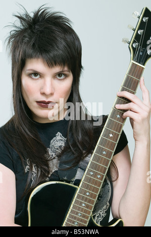 Hispanic woman holding guitar Stock Photo