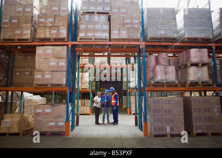 Workers talking in warehouse Stock Photo