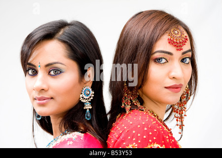 Two beautiful Bengali brides in colorful dresses isolated Stock Photo