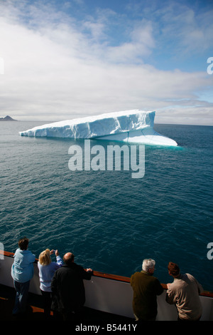 Aug 2008 - Passengers on a cruise ship looking at an Iceberg in Arsuk Fjord along the southwest coast Greenland Stock Photo