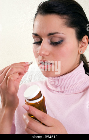 young woman taking pills Stock Photo