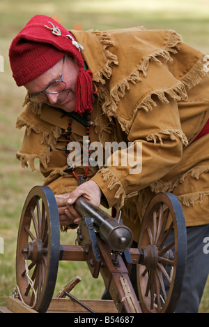Man wearing trapper costume demonstrating black powder cannon at Steam Engine Show at Westwold, 'British Columbia', Canada Stock Photo