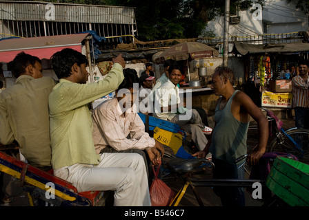 Rickshaw drivers waiting for customers at New Delhi train station. Stock Photo