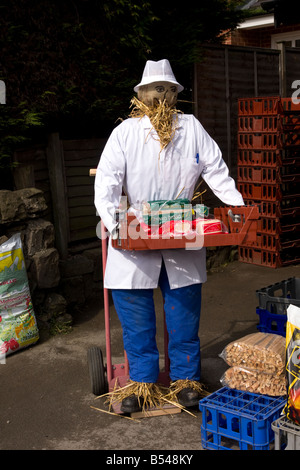 traditional derbyshire village custom straw man scarecrow baker with bread Stock Photo