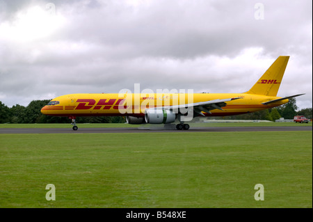 A DHL Boeing 757 200 landing on a runway Stock Photo