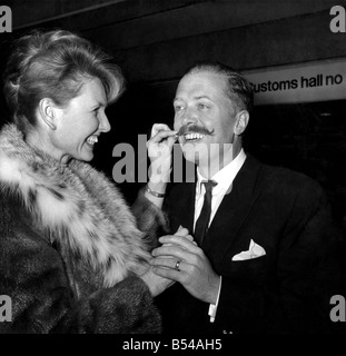 Actor Richard Attenborough is greeted at London Airport on Thursday by his wife Sheila Sim. He has just returned from Formosa where he has been filming in a new picture 'The Sand Pebbles' with Steve McQueen. ;March 1966 ;P016941 Stock Photo