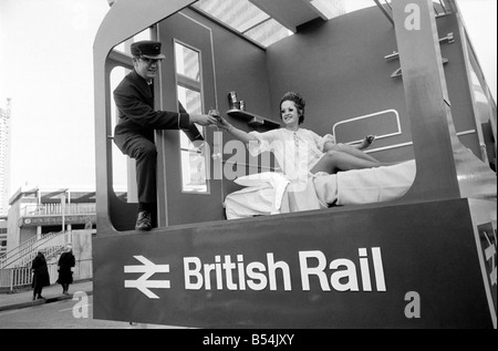 The British Rail float had the attraction of pretty Peni Hobbs from Kensington advertising their sleeping cars. Peni in only a nightdress was so cold that a typical British Rail porter came to her rescue with a glass of whisky to warm her up. ;November 1969 ;Z10778-002 Stock Photo