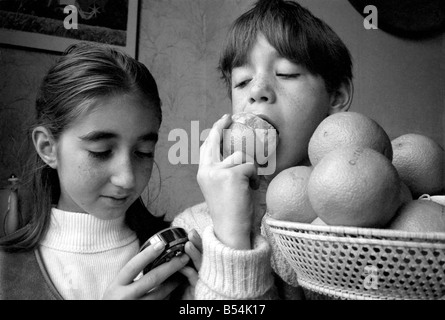 Matthew Ives, timed by his sister Sally, 11, eating his way to a world record by consuming 12 oranges weighing 33/4 lbs in 4 Minutes 52 Seconds. ;November 1969 ;Z10805-001 Stock Photo