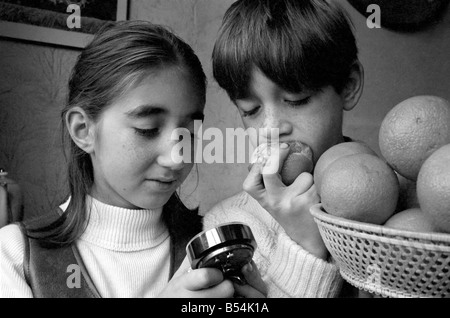 Matthew Ives, timed by his sister Sally, 11, eating his way to a world record by consuming 12 oranges weighing 33/4 lbs in 4 Minutes 52 Seconds. ;November 1969 ;Z10805-002 Stock Photo