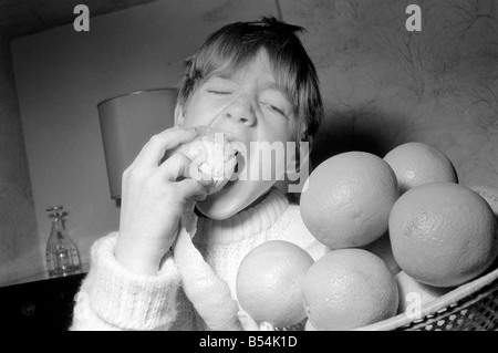 Matthew Ives, timed by his sister Sally, eating his way to a world record by consuming 12 oranges weighing 33/4 lbs in 4 Minutes 52 Seconds. ;November 1969 ;Z10805-003 Stock Photo