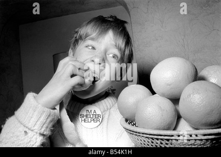 Matthew Ives, timed by his sister Sally, eating his way to a world record by consuming 12 oranges weighing 33/4 lbs in 4 Minutes 52 Seconds. ;November 1969 ;Z10805-004 Stock Photo