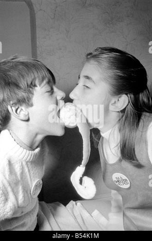 Matthew Ives, timed by his sister Sally, 11, eating his way to a world record by consuming 12 oranges weighing 33/4 lbs in 4 Minutes 52 Seconds. ;November 1969 ;Z10805-005 Stock Photo