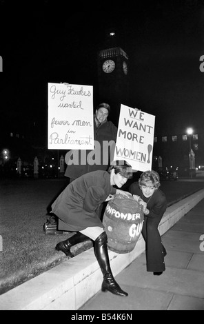 Actress Diane Heart and members of her pressure group for women in Parliament staged a guy fawkes demonstration outside the house of commons. Miss Heart who is starring in 'The Man Most Likeley to' at the Vaudeville theatre arrived in parliament square with a barrel full of beer and marked 'Gunpowder'. After the demonstration actress Diane went straight of the theatre to play her part. L. to. R. Actress Erika Brand, playrite Mrs Irene Coates, and Diane Heart. November 1969 Z10693-001 Stock Photo