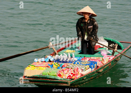 Woman selling goods from a boat in Halong Bay, Gulf of Tonkin, Vietnam Stock Photo